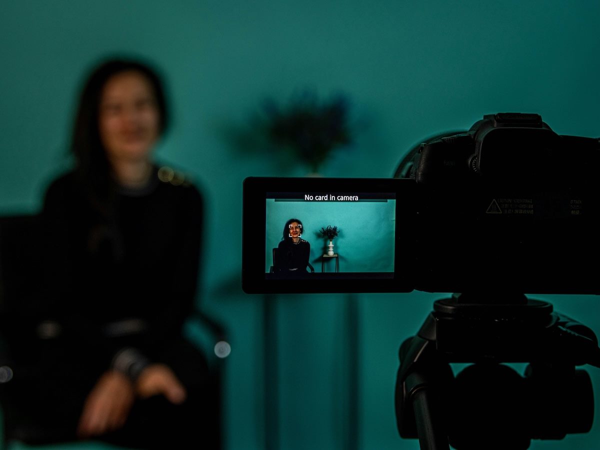 woman job candidate speaking into a camera for an interview