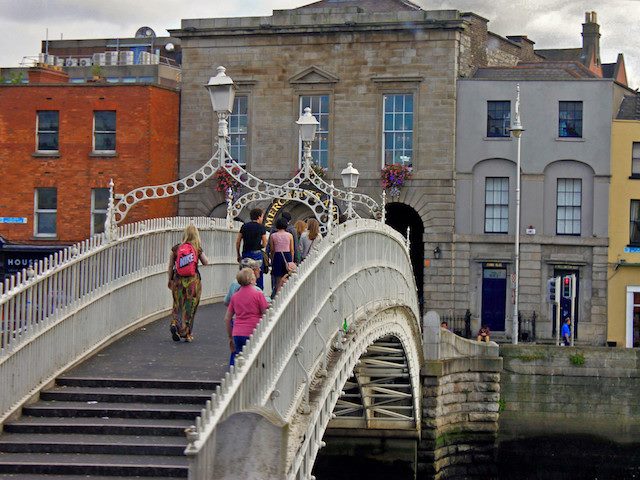 people crossing the Ha'Penny bridge in Dublin