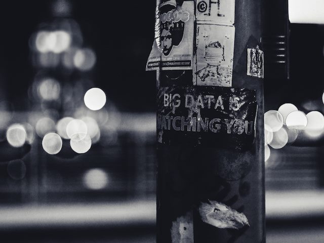 flyer pasted on a post that reads "Big Data Is Watching You"