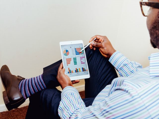 man looking at analytics on ipad