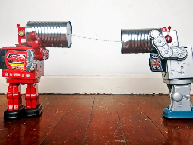 Retro robots on tin can phones. 