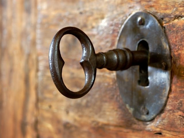 Closeup of an old keyhole with key.