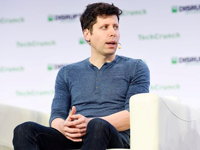 OpenAI's Sam Altman at a tech conference on stage sitting down.
