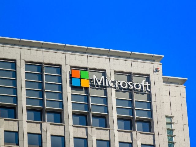 Microsoft building, viewed from outside, with Microsoft logo on building.