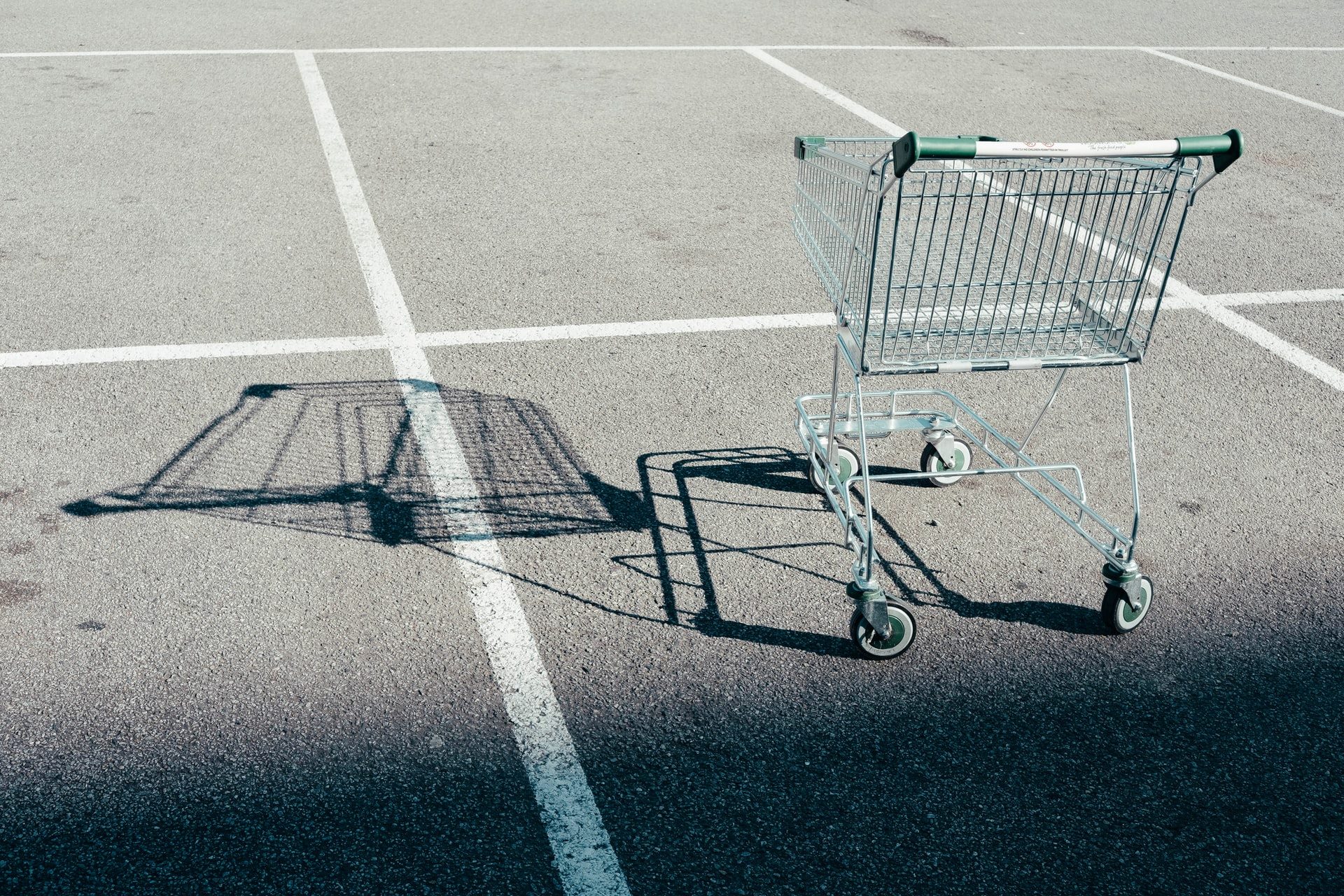 An abandoned shopping cart in a parking lot