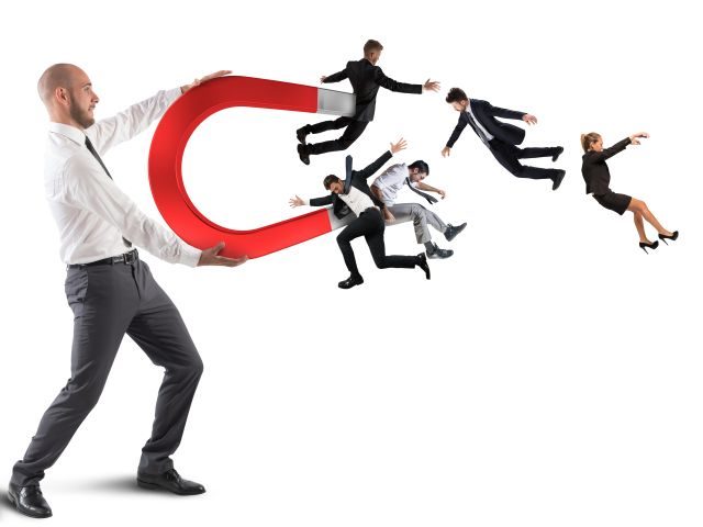 Businessman attracts workers with a big magnet