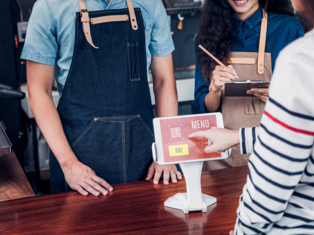A customer using a self-service kiosk - automation technology concept