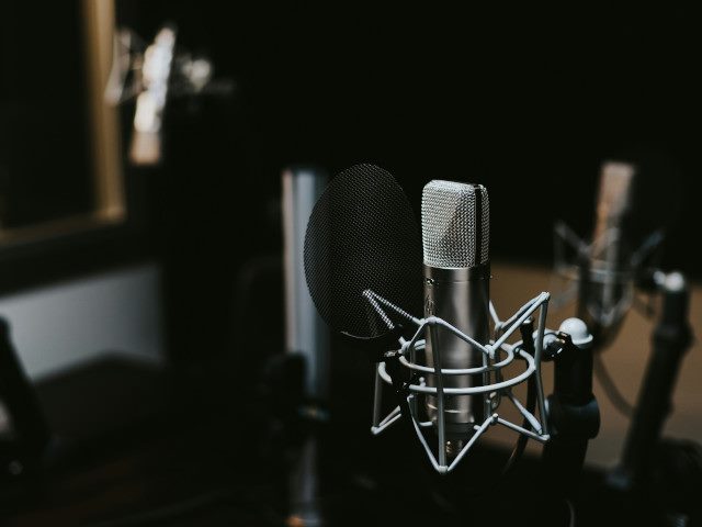 A microphone in a music recording studio room.