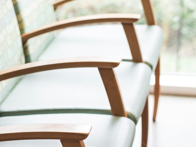 A row of waiting room chairs beside a window.