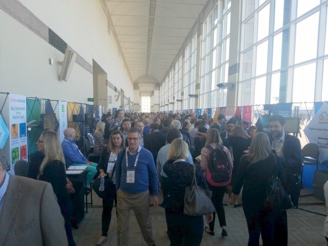 MarTech conference attendees walk through the vendor exhibition hall at the Hynes Convention Center.