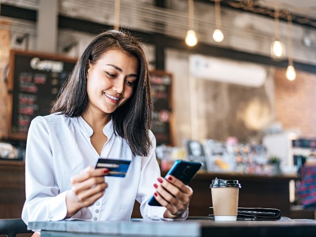 Woman paying online with her card