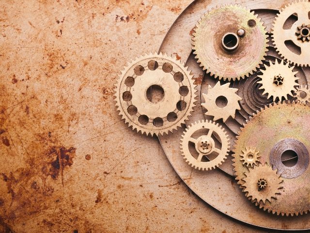 Gears and machine parts scattered on the right and vintage sepia background