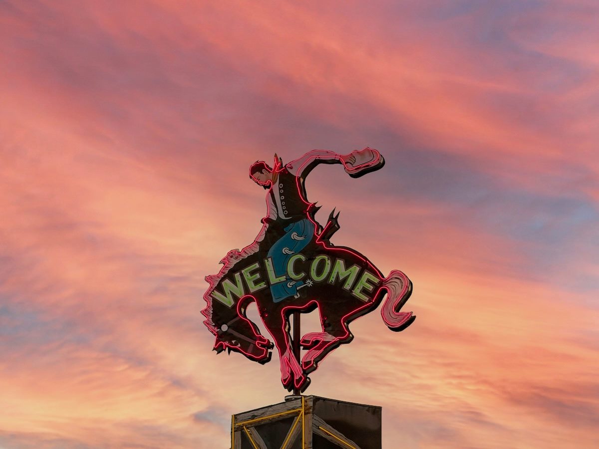 neon welcome sign in the shape of a cowboy riding a bucking horse