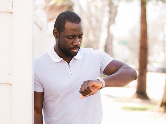 man looking at watch