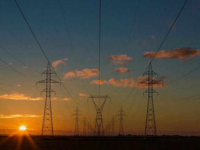 a series of powerlines going off into the sunset