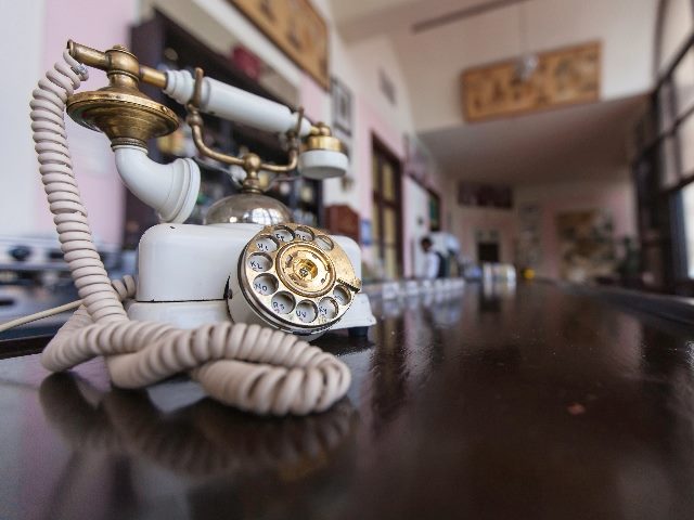 Old-fashioned white telephone.