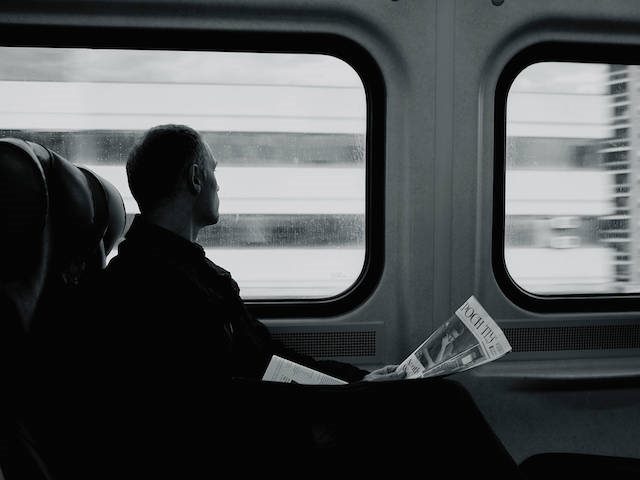 man on train with a newspaper