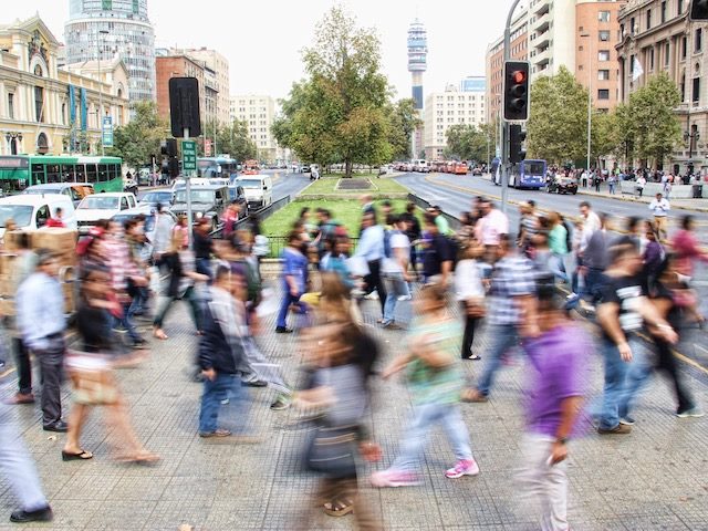 time lapse photo of people walking through a busy intersection