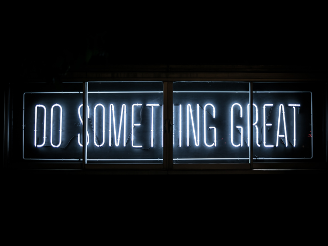 A neon sign that says "Do something great"