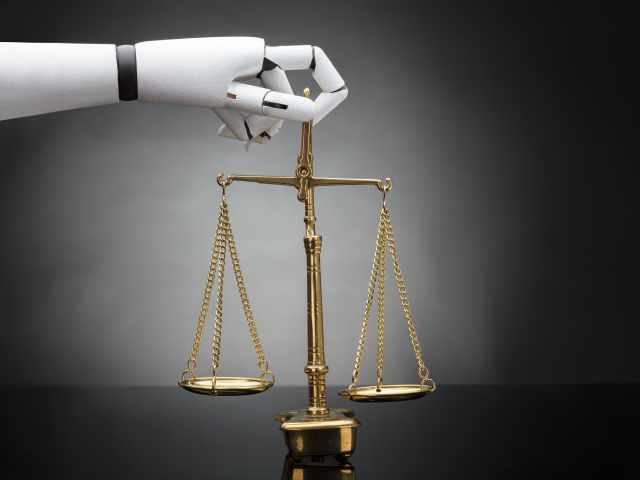 Close-up Of A Robot's Hand Holding Justice Scale On Grey Background