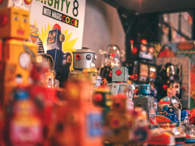 Toy robots lined up perhaps at a store for sale.