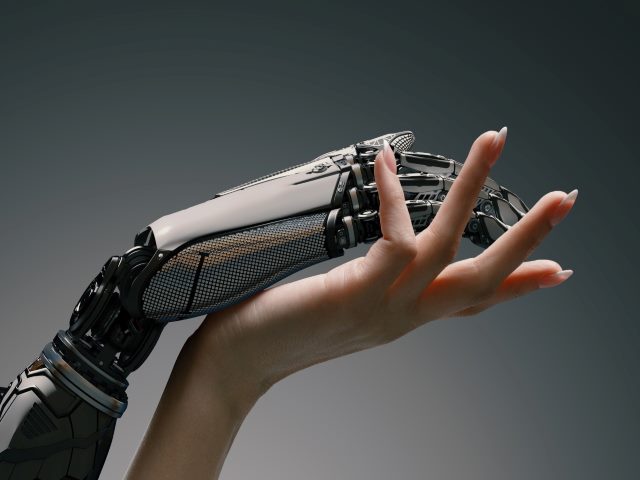 A female hand  gently touching a robot hand, with an artificial intelligence augmented reality collaboration friendship concept