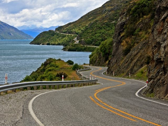 Scenic lake road through the mountains in New Zealand.