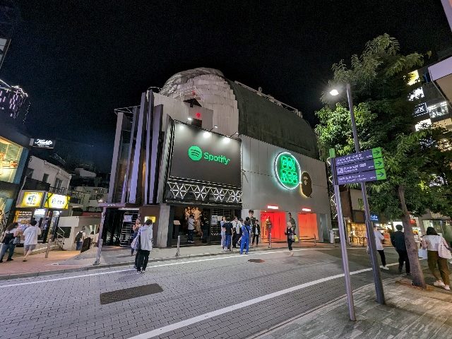 spotify building on a busy street.