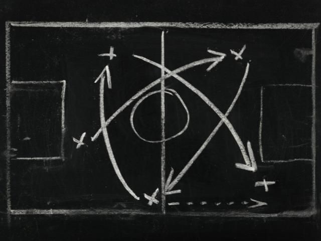 A sports game plan on a chalkboard