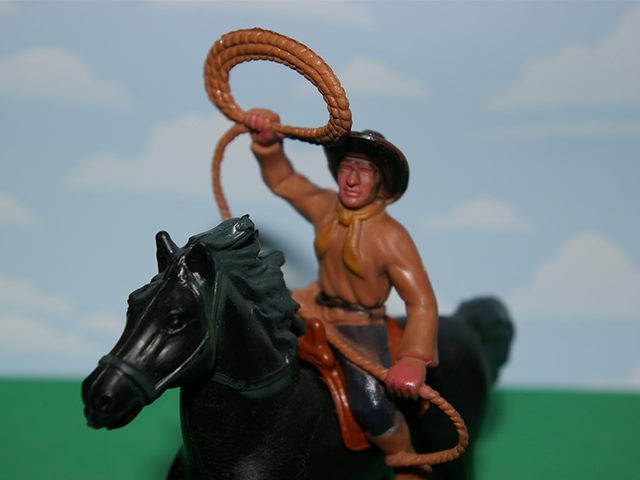 Image of a toy of a cowboy riding a horse.