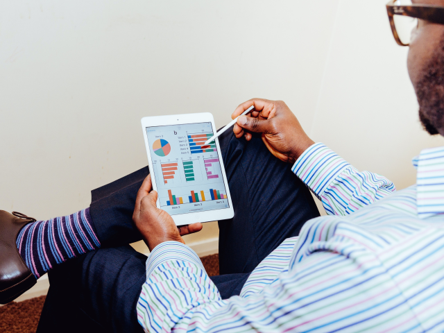 A man looking at a marketing analytics dashboard that was built via marketing automation software