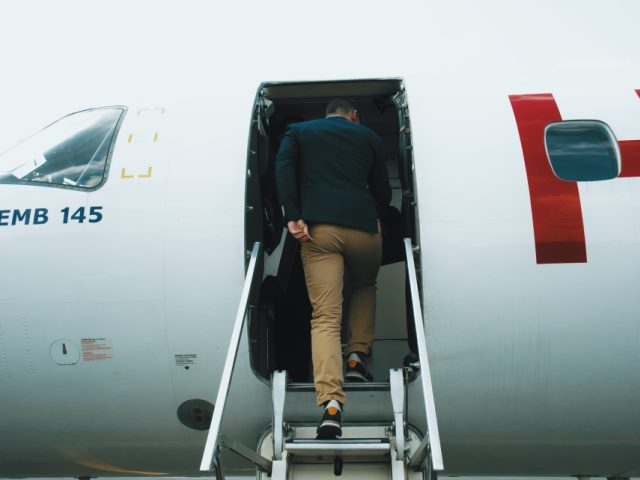 photo of a man boarding a plane