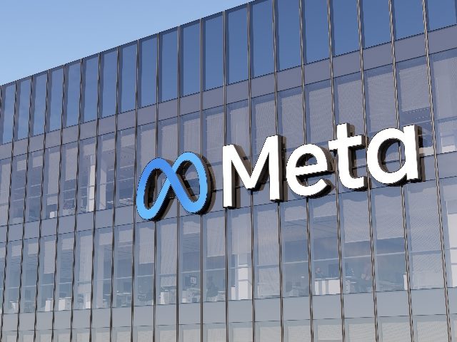 Meta signage logo on top of glass building at Menlo Park, Calif. headquarters.
