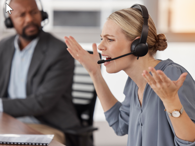 A frustrated customer support agent with hands raised. She is wearing a headset and talking to a customer. 