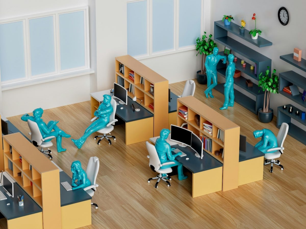 Aqua-colored figures sitting in office chairs in a work environment set-up built with toys.