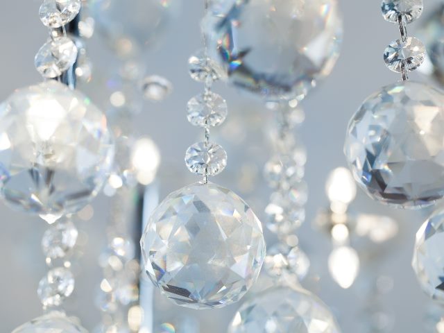 Cut chandelier crystals dangle in the light.