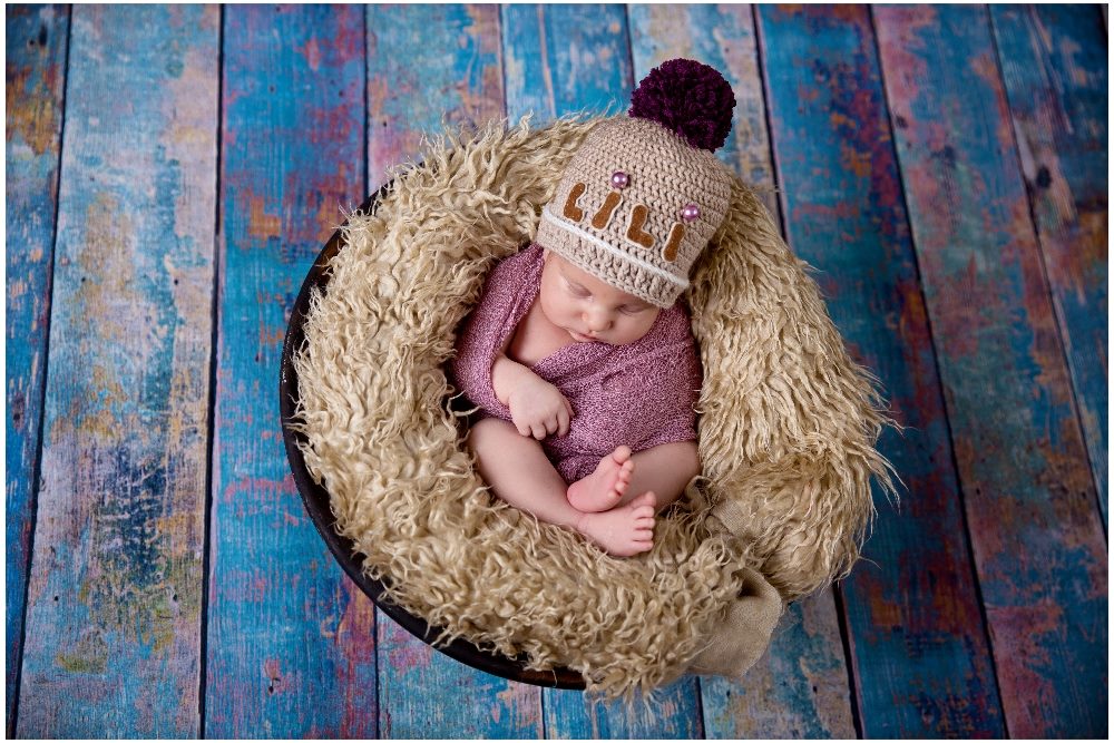 A baby named Lili wears a cute knit hat with her name embroidered on it and sits in a fuzzy encircling basket, suggesting the importance of personalized customer experience.
