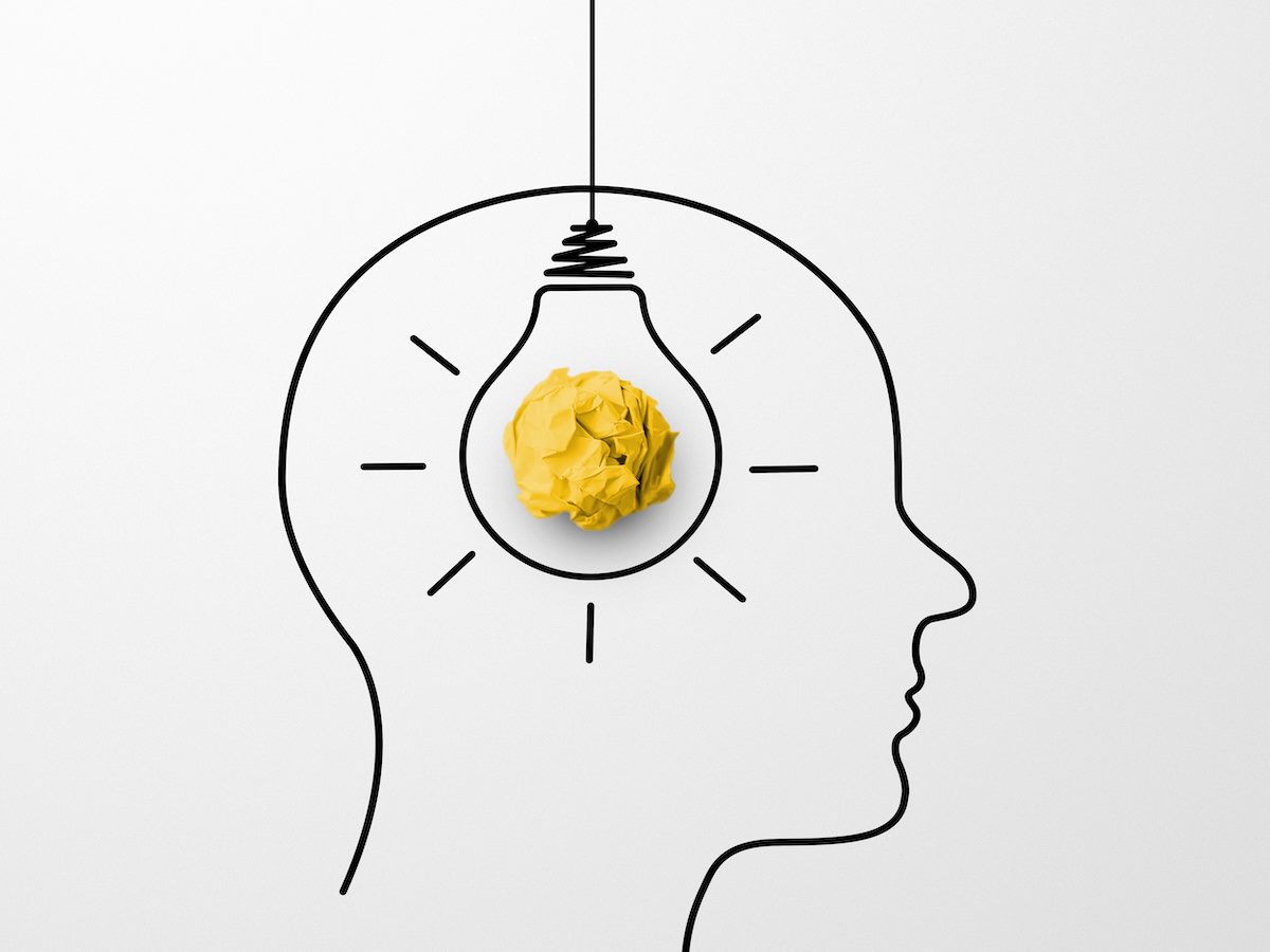 Paper scrap ball yellow colour and light bulb in head human