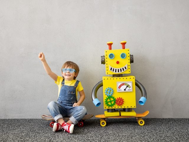 Happy child with toy robot.
