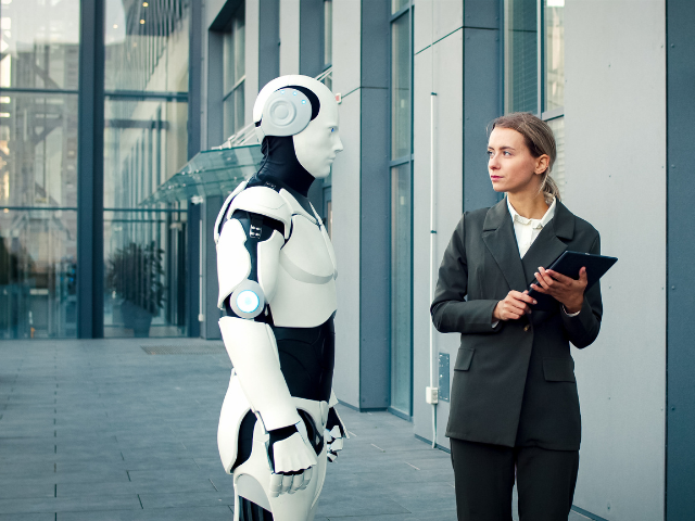 A robot and a person looking at each other 