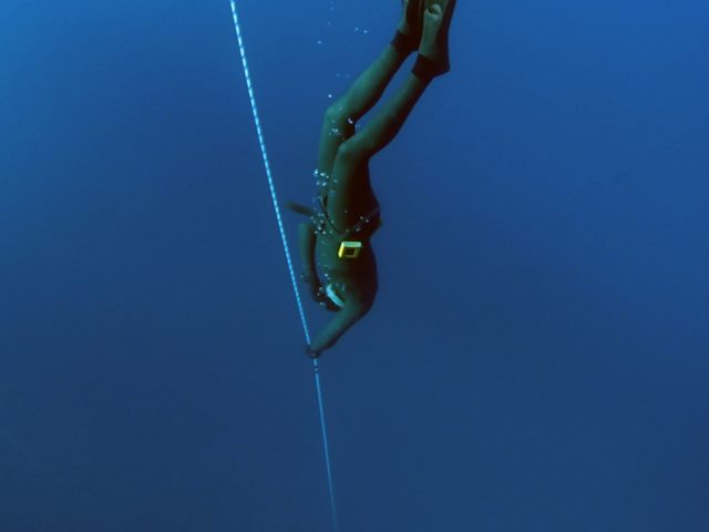 underwater diver with a cord