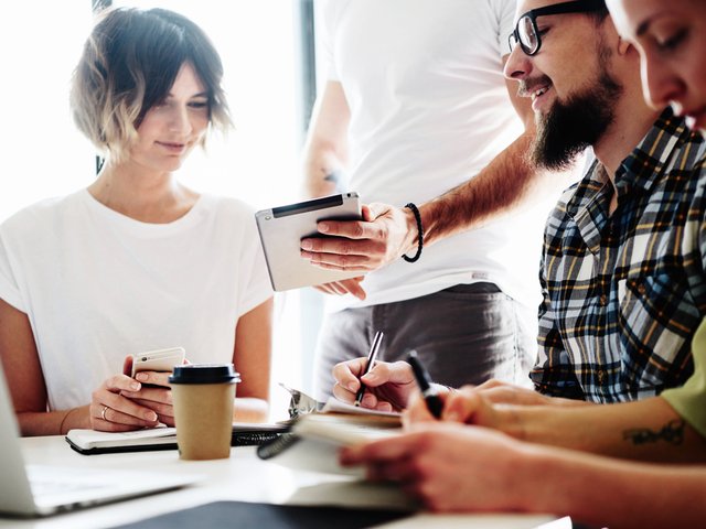 Young financial industry marketers are reviewing the latest data on the corporate intranet.