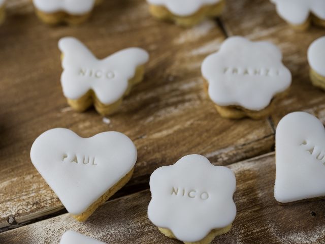 Personalized cookies with frosting and names inscribed on them.