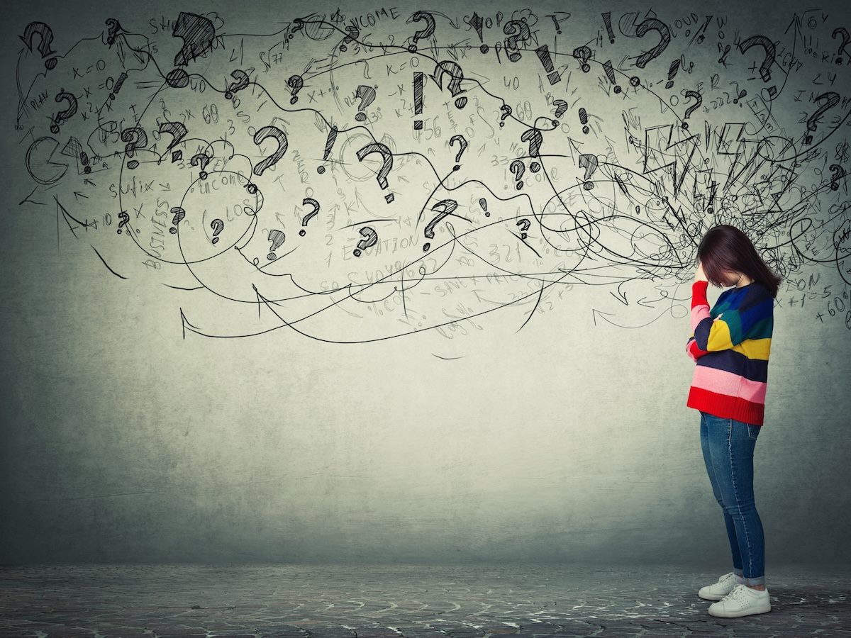 person worrying with a background of questions and thought lines sketched behind them