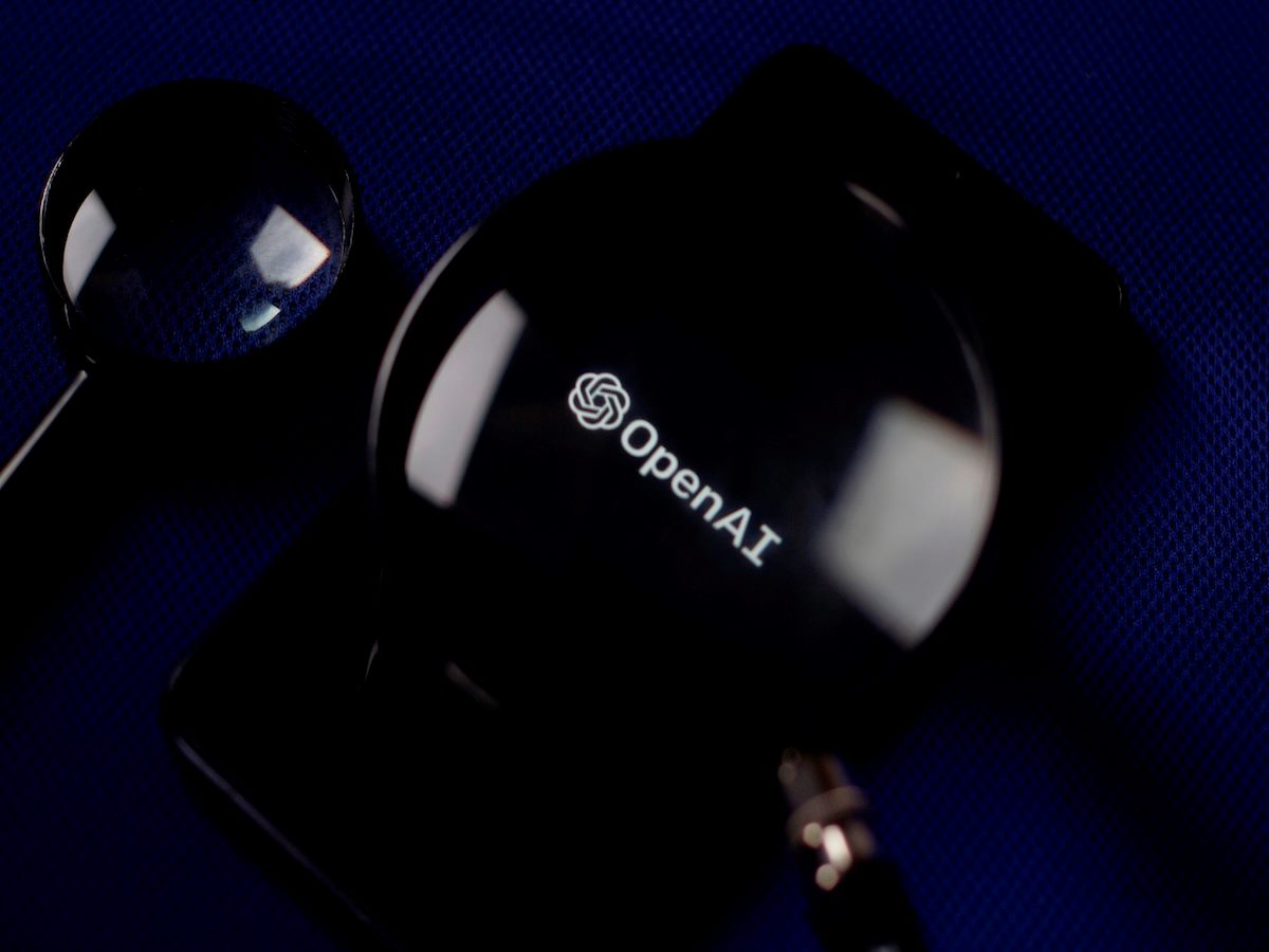 OpenAI logo under magnifying glass