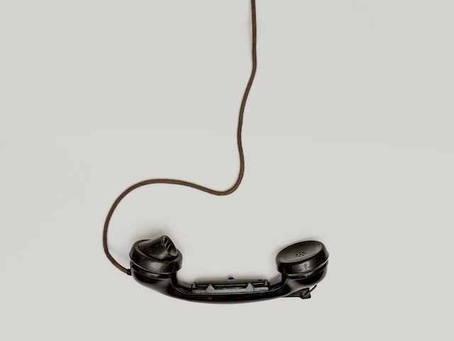 old  phone off the hook against a white background