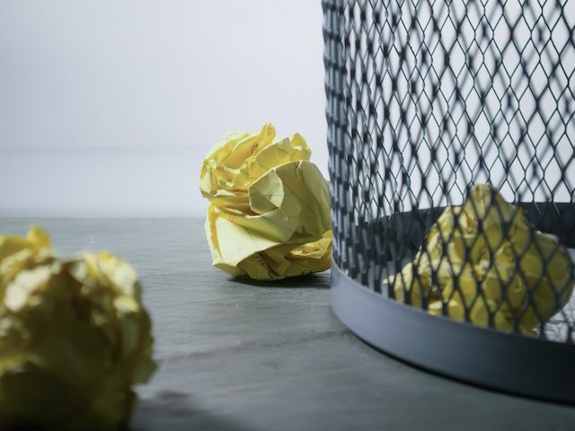 balled up paper in the waste basket