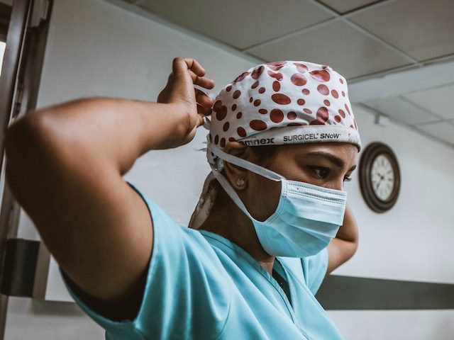 doctor putting mask on at work