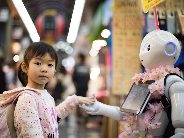 Pepper robot and young girl