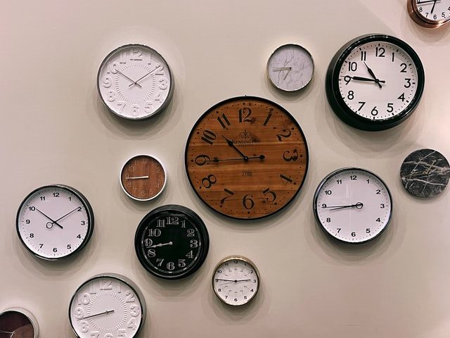 A wall with multiple clocks on it